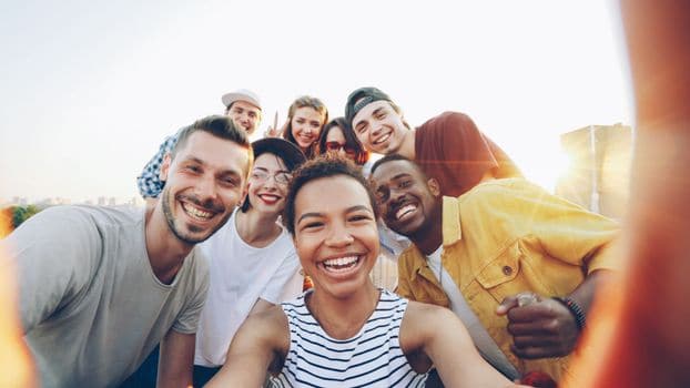 Sterile Tech Jobs Near Me: How Hospitals Can Win the Local SPD Talent Competition 1 A diverse group of friends taking a joyful selfie outdoors during sunset.