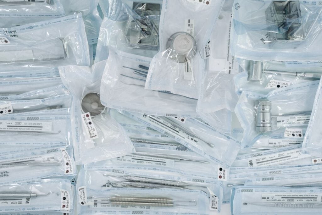 SPD Agency or Outsourced Department? What Hospital Leaders Are Actually Choosing Between 2 A collection of sterilized dental tools individually sealed in plastic wrap for hygiene.